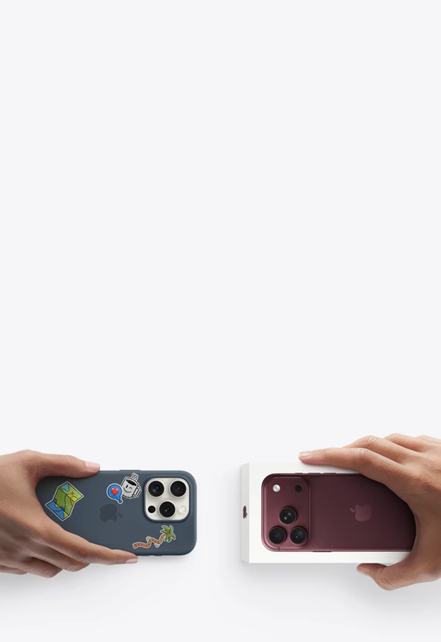 Image showing a hand holding an old iPhone and another hand holding a new iPhone in its box.